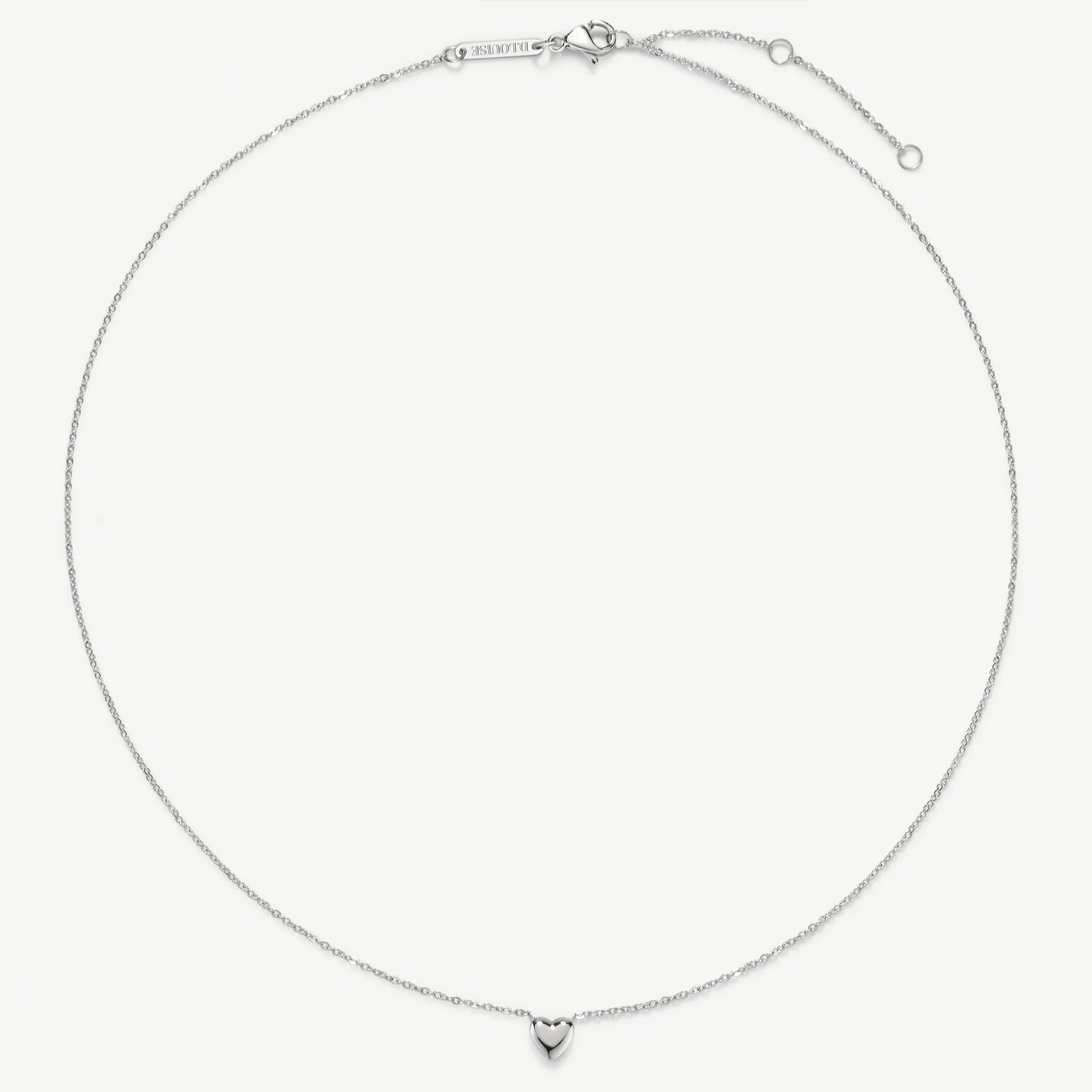 Delicate silver necklace with a small heart charm pendant on a fine chain