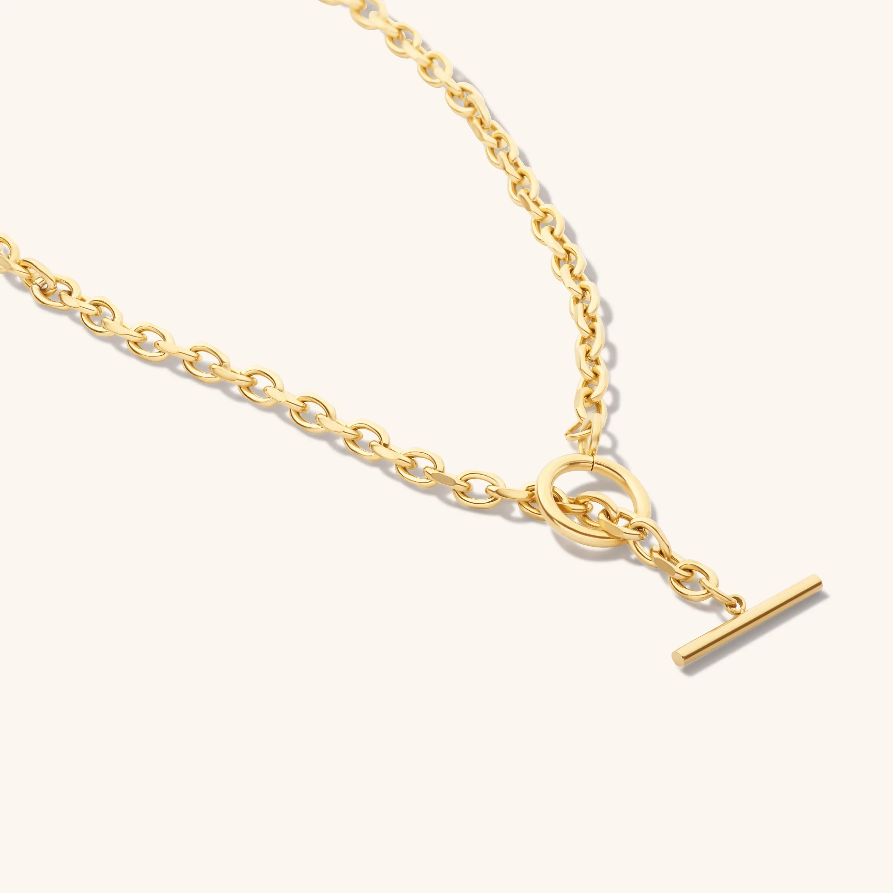 gold chain necklace with toggle clasp on light background elegant jewelry