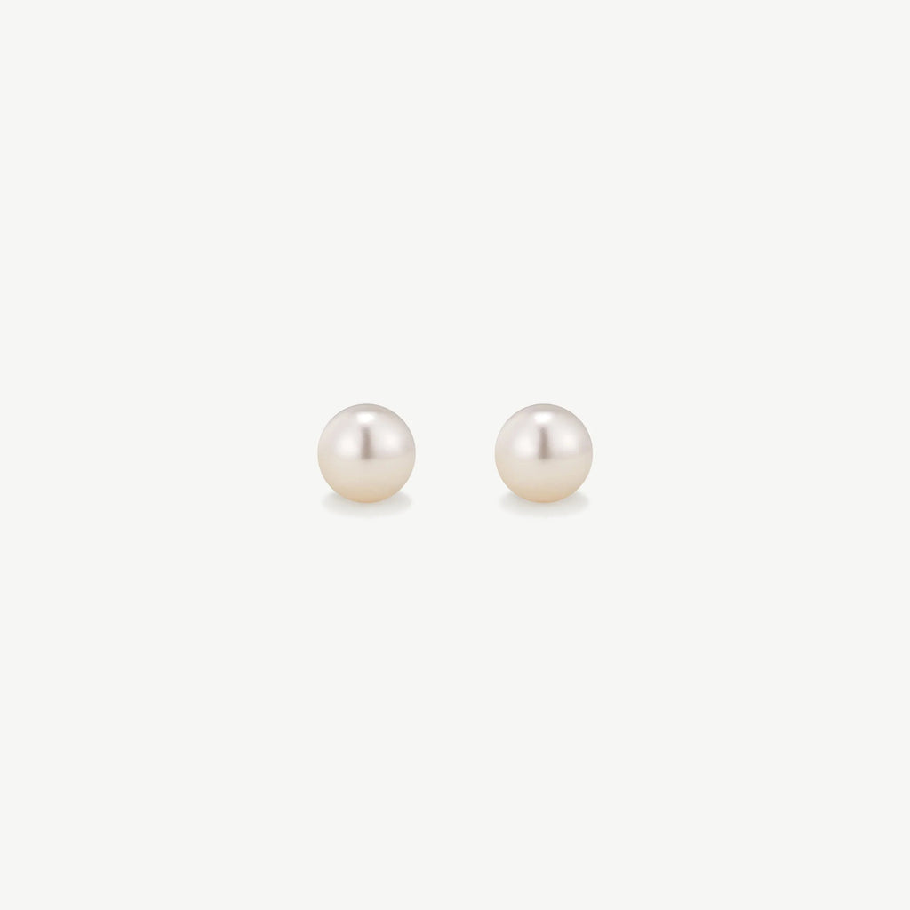 Pair of classic white pearl stud earrings on a white background