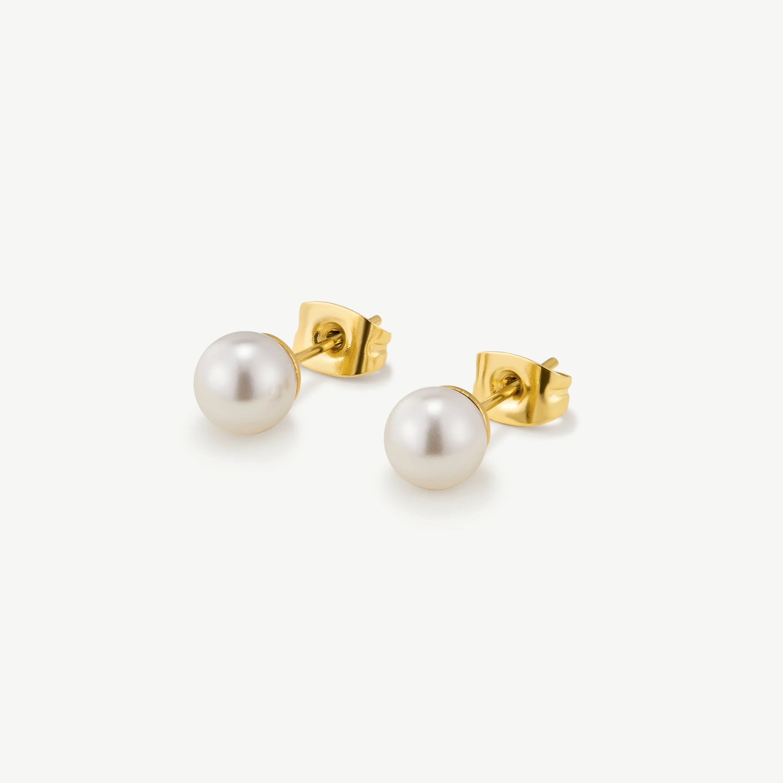 Elegant pearl stud earrings with gold backing on white background