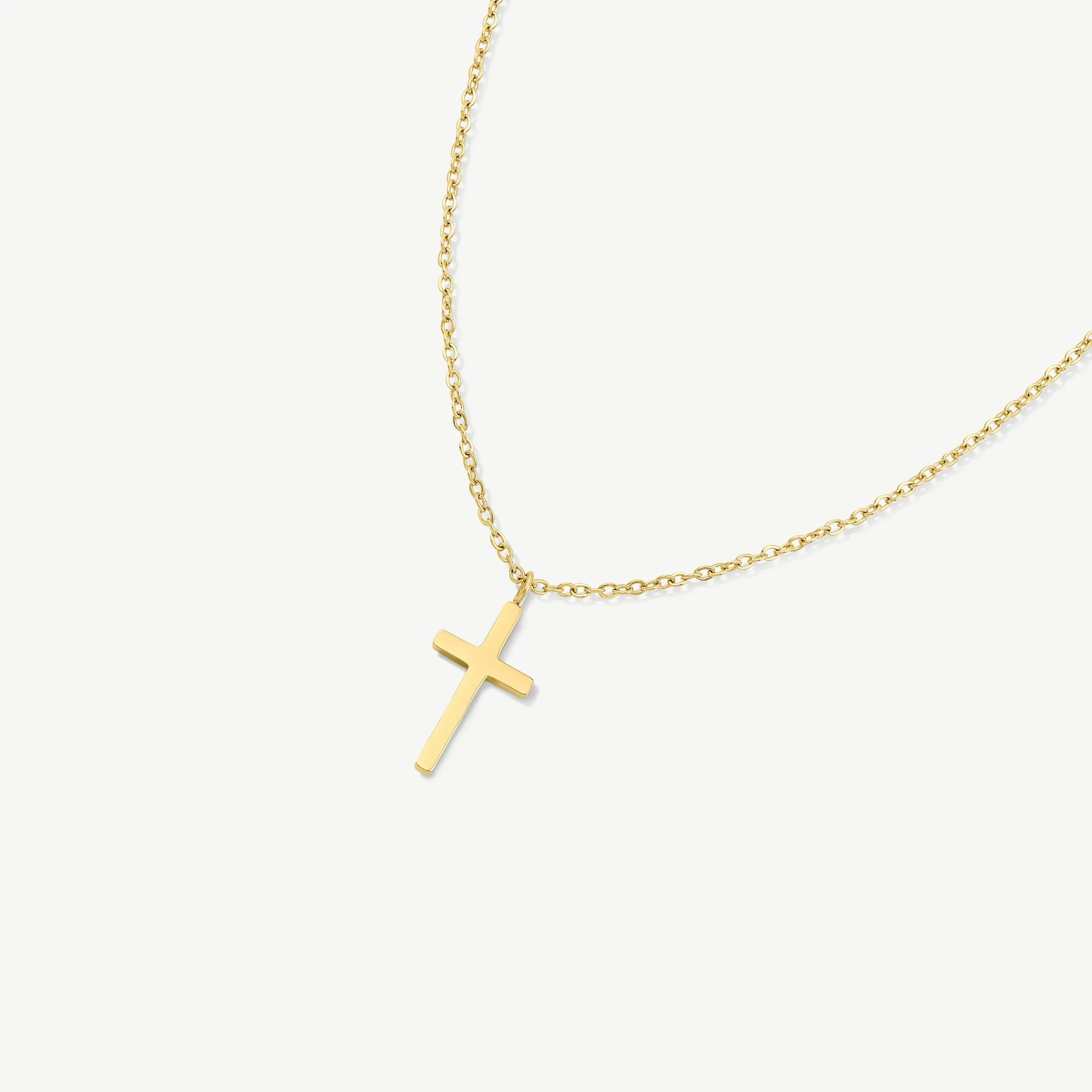 Gold chain necklace with a simple gold cross pendant on white background