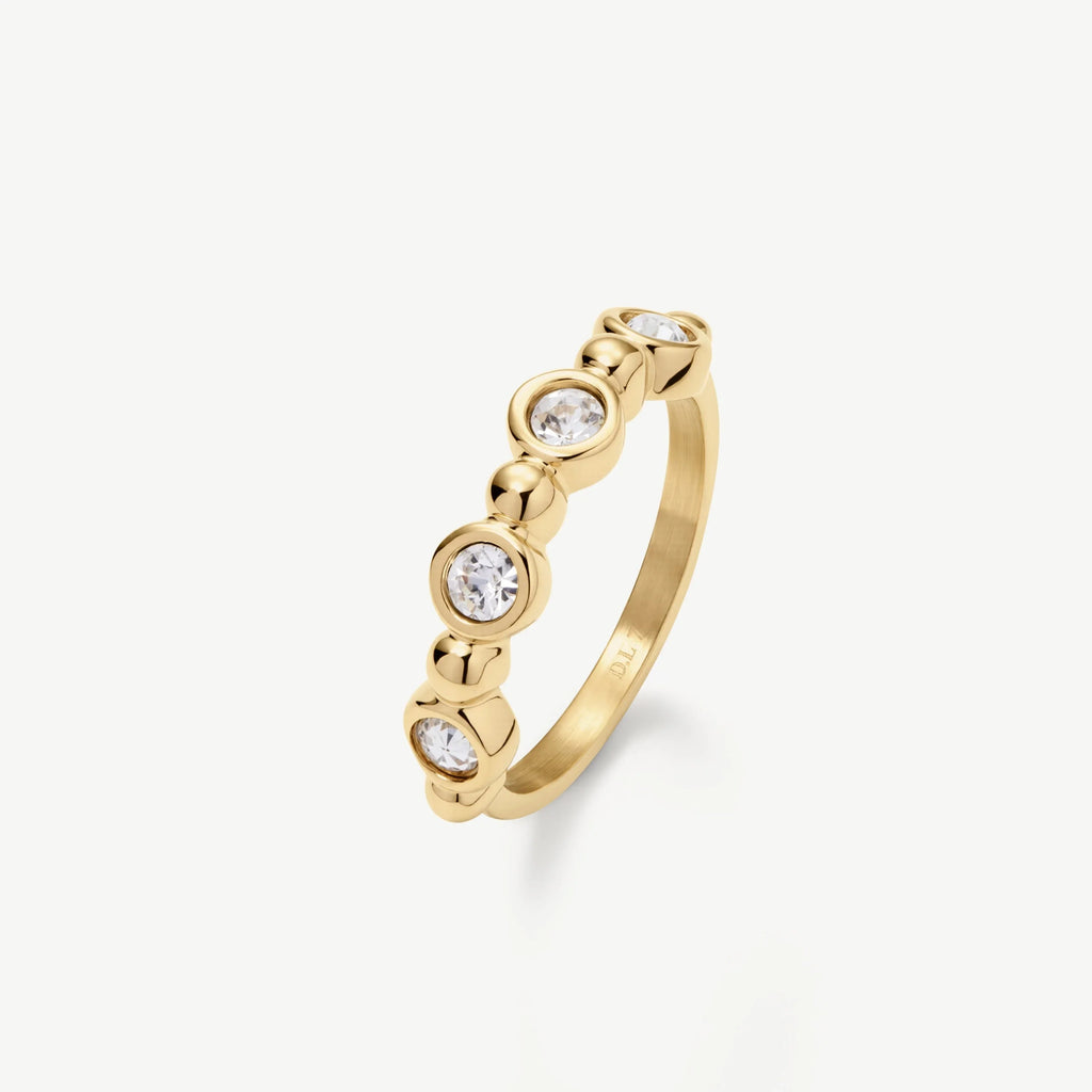 Gold ring with five clear round gemstones set in a bezel with polished gold accents