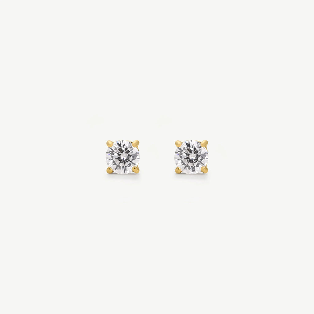 Pair of round diamond stud earrings in four-prong yellow gold settings on white background