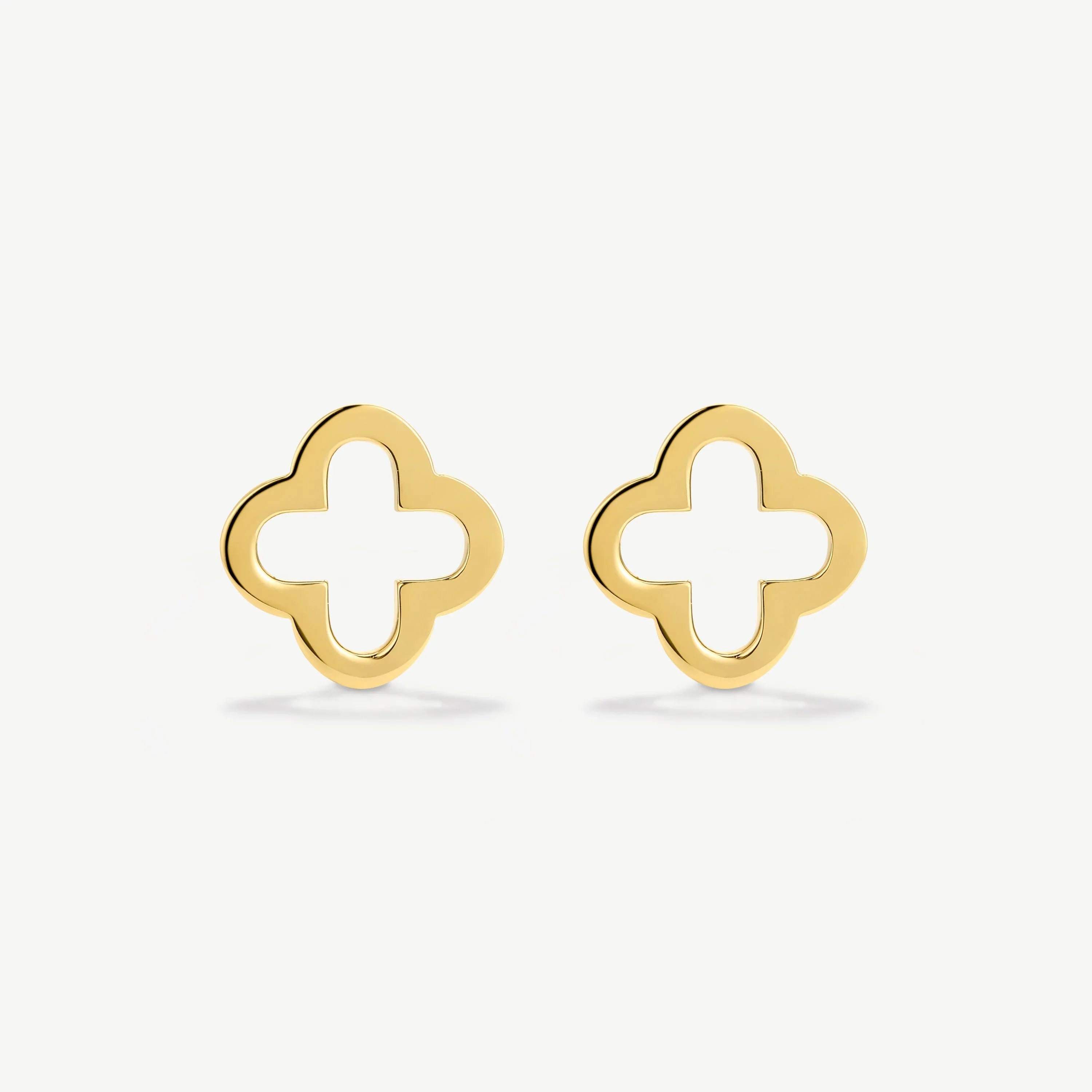 Pair of gold-tone open quatrefoil stud earrings on white background