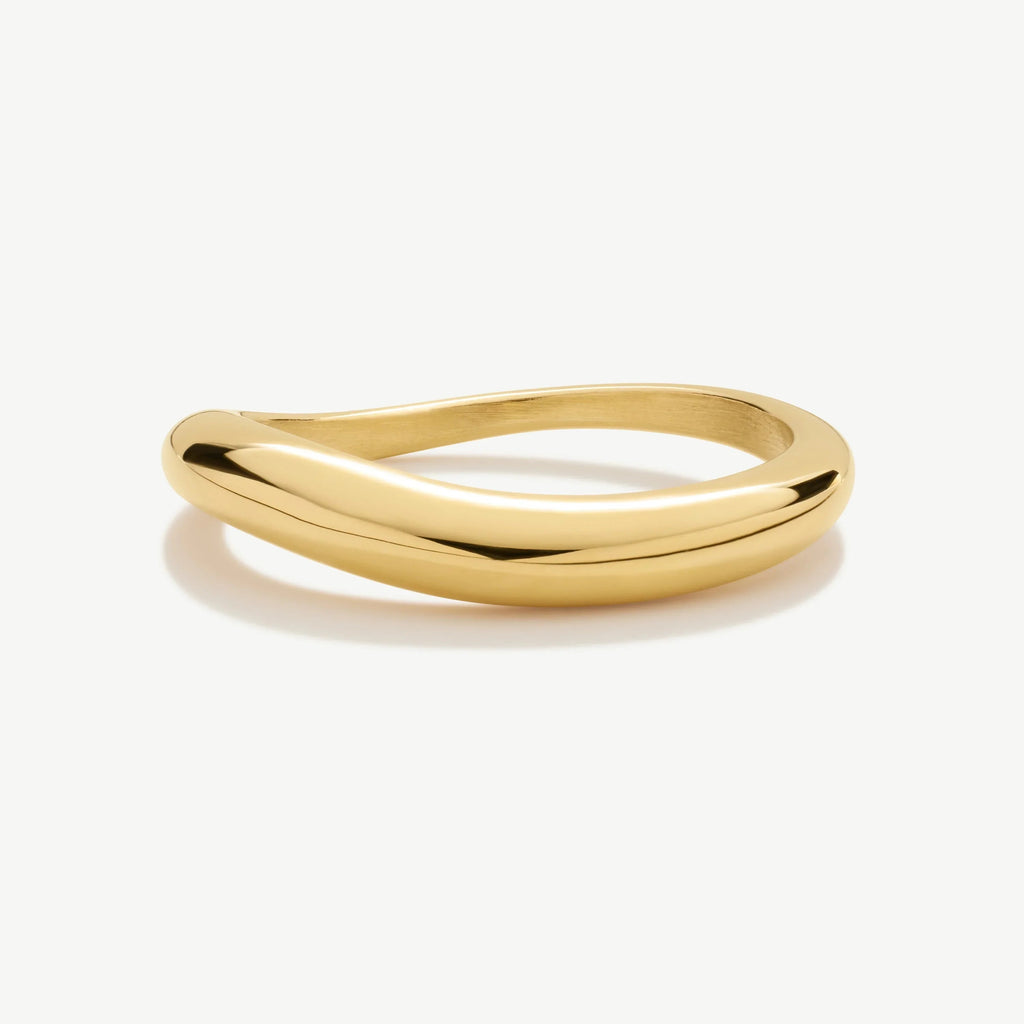 Polished gold twisted bangle bracelet on white background, modern minimalist jewelry