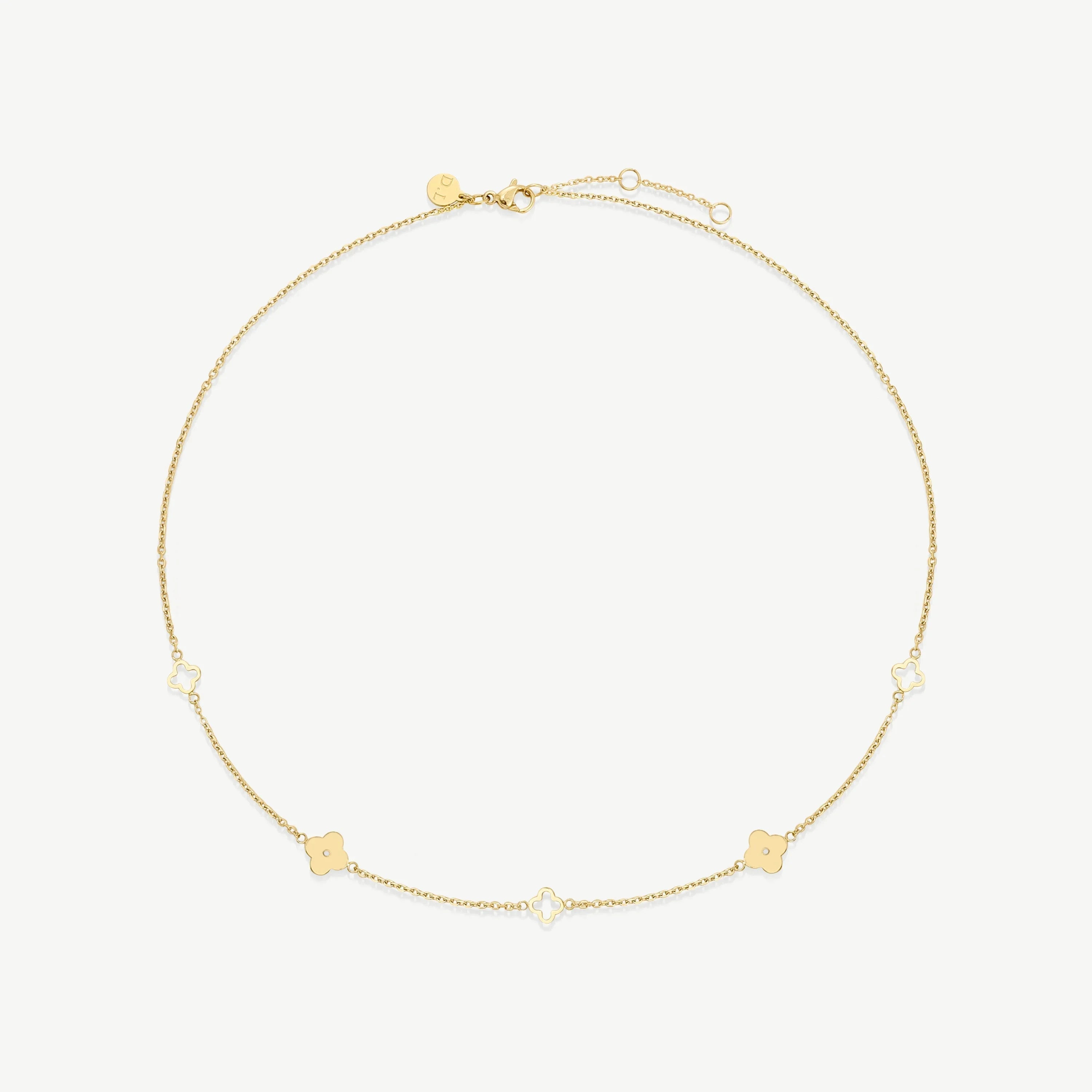 Delicate gold chain necklace with alternating solid and hollow four-leaf clover charms on white background
