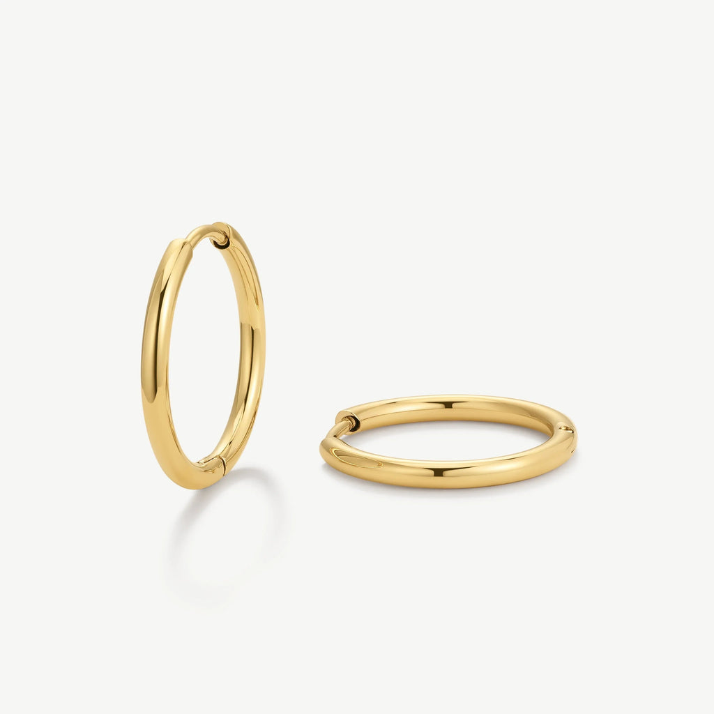 Pair of polished gold hoop earrings on white background