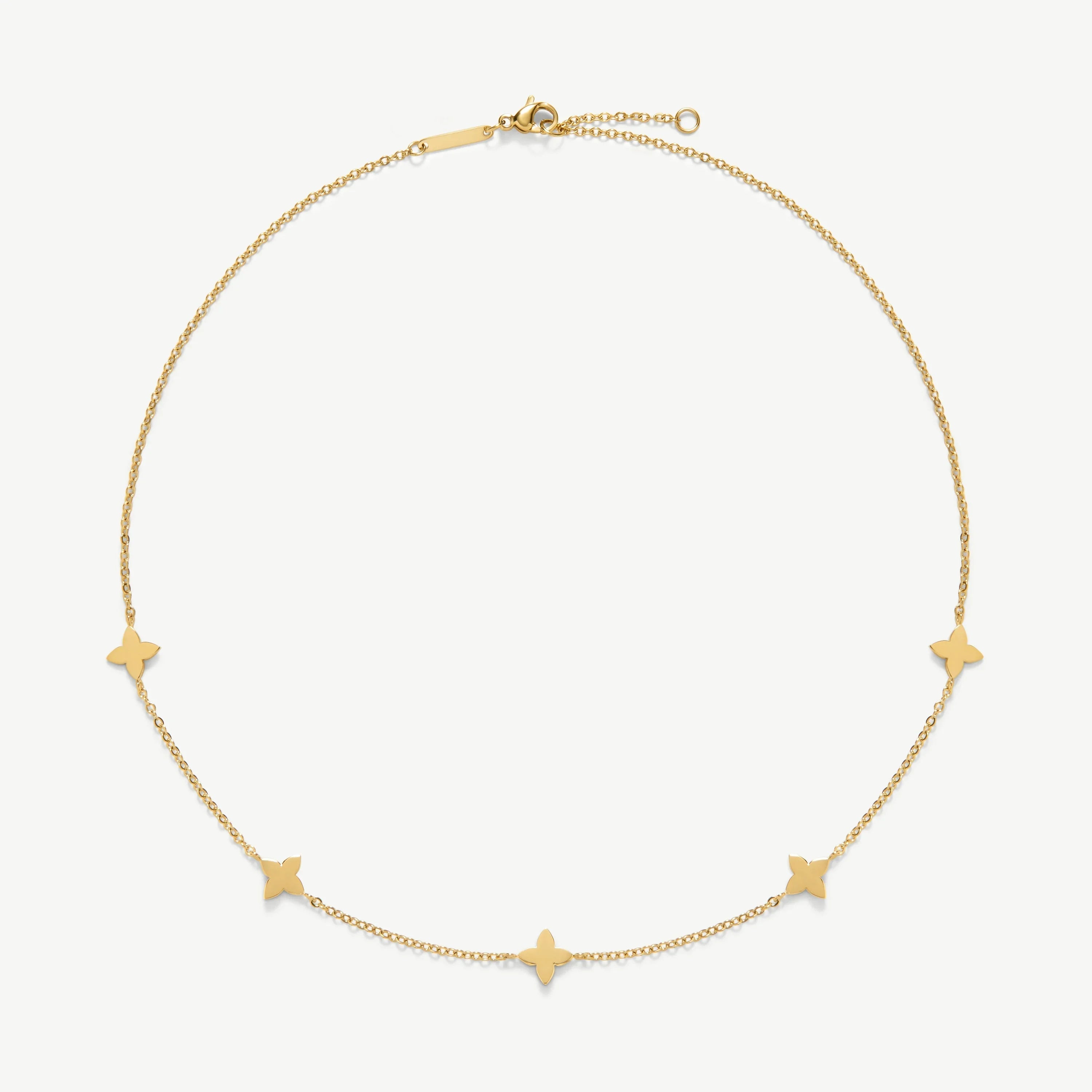 Delicate gold chain necklace with five small butterfly-shaped charms on white background