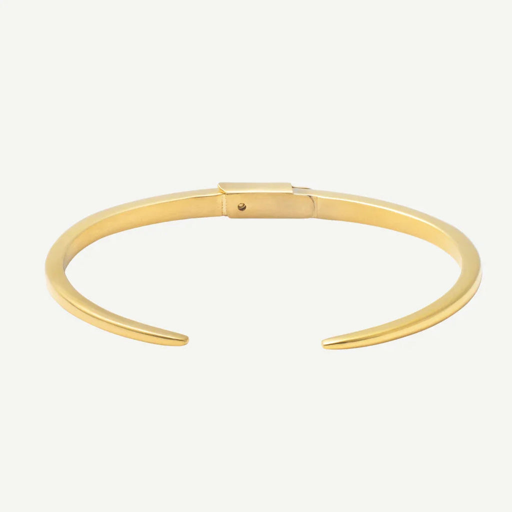 Minimalist gold cuff bracelet with open ends and smooth finish on white background