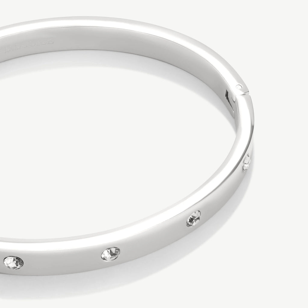 Silver bracelet with embedded clear crystals on white background