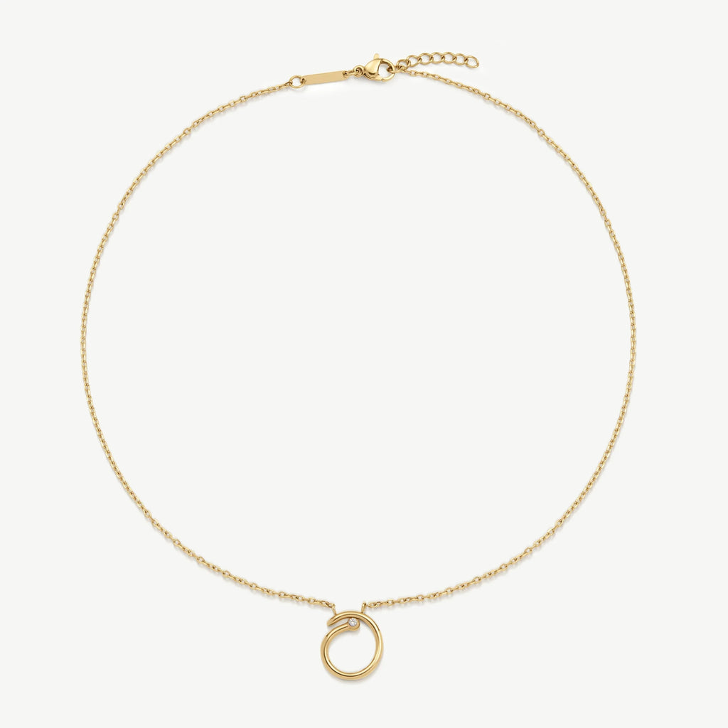 Delicate gold chain necklace with circular pendant featuring small gemstone detail