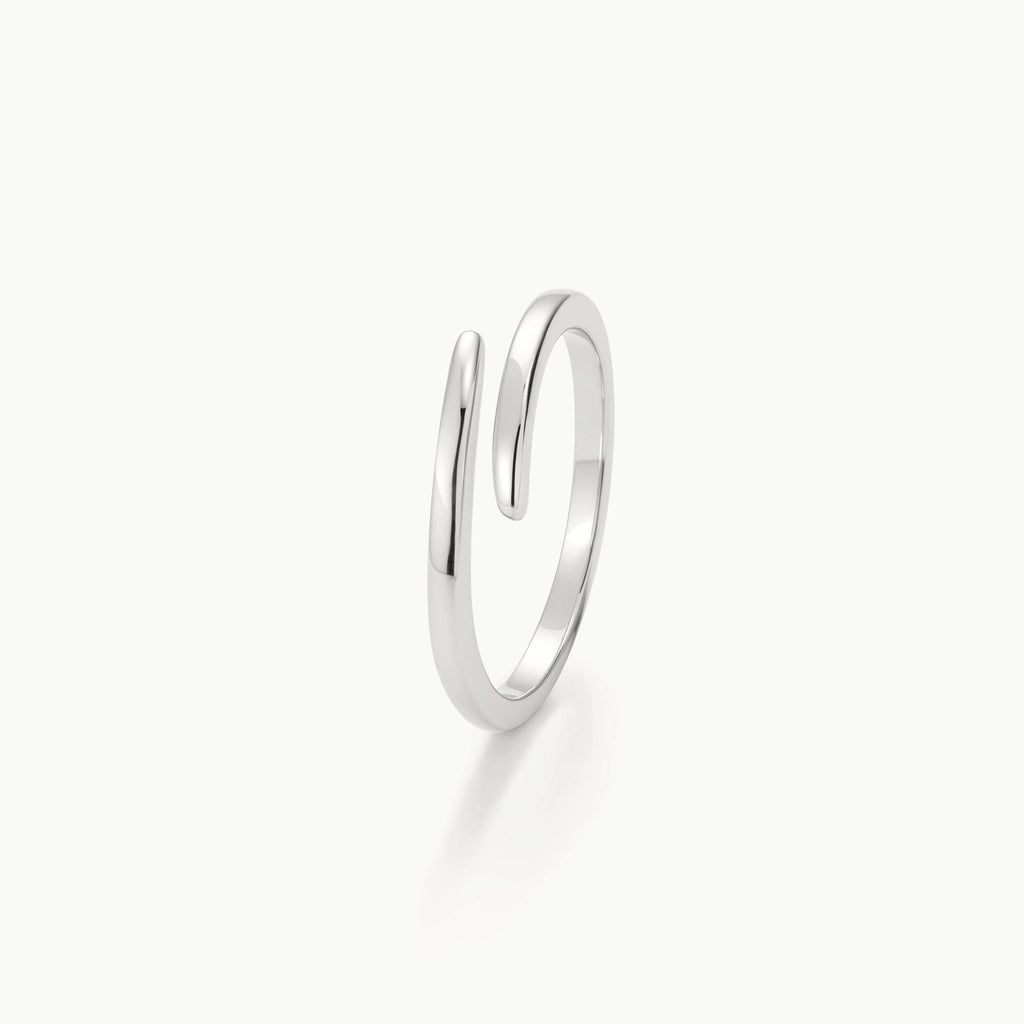 Minimalist adjustable open silver ring with polished finish on white background