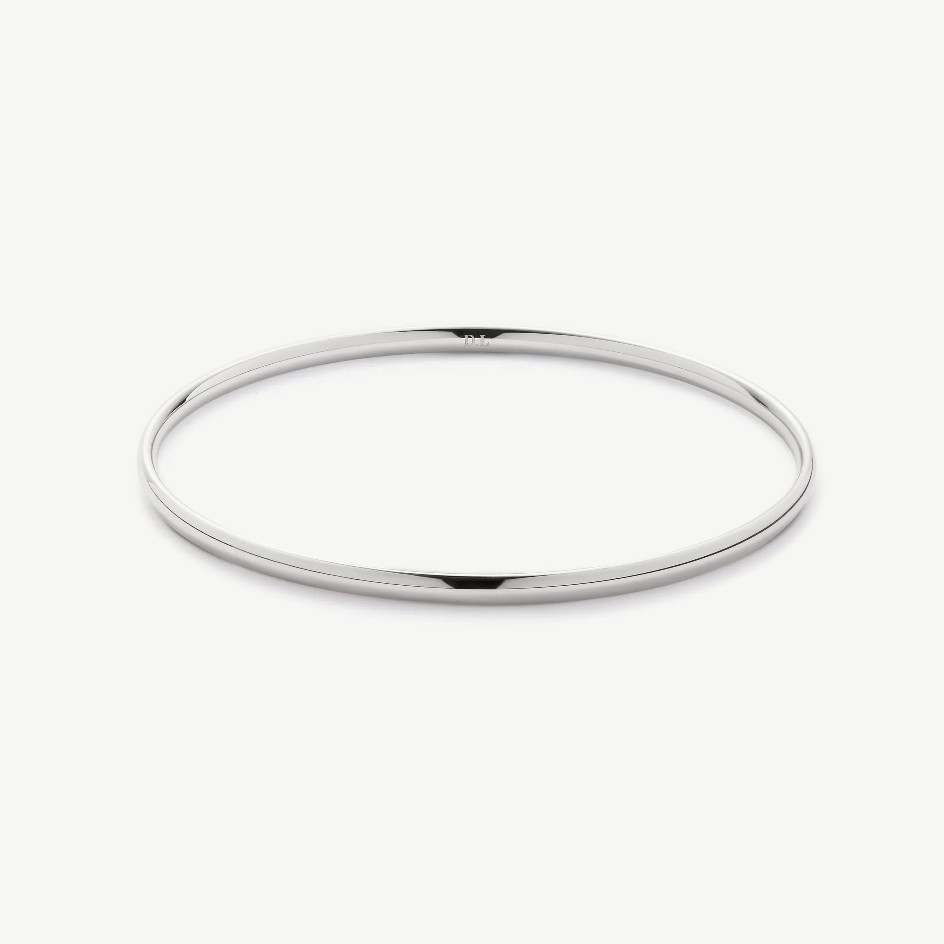 Minimalist silver bangle bracelet on white background