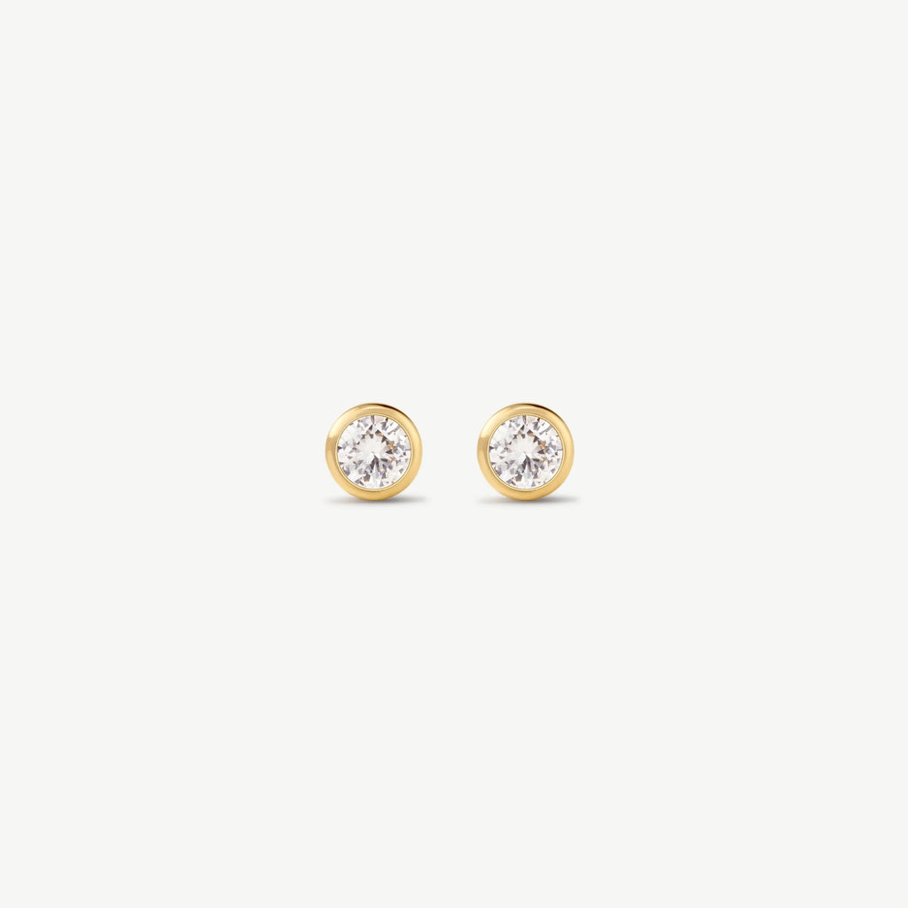 Pair of gold bezel-set diamond stud earrings on white background